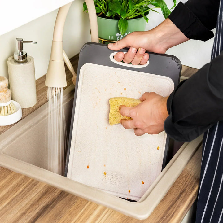 Stainless steel cutting board with a smooth finish and non-slip ergonomic handle, ideal for precise and hygienic kitchen prep