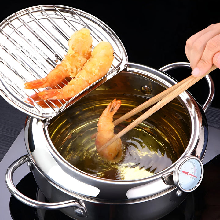 "Stainless steel deep fryer pot with thermometer, silver, heat-resistant handles, and oil drainer rack for safe frying."