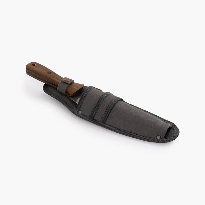 "Stainless steel Hori Hori garden tool with ergonomic walnut handle for digging and weeding in gardens."