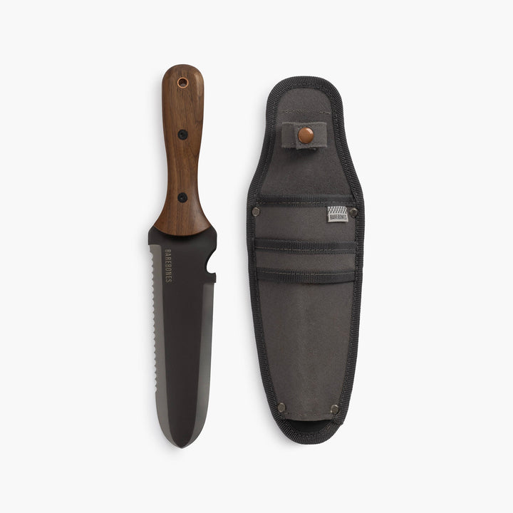"Stainless steel Hori Hori garden tool with ergonomic walnut handle for digging and weeding in gardens."