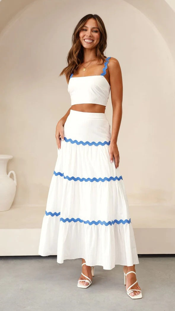 Strapless crop top and tiered maxi skirt set, lightweight with wavy trim, perfect for summer events. Women's fashion ensemble