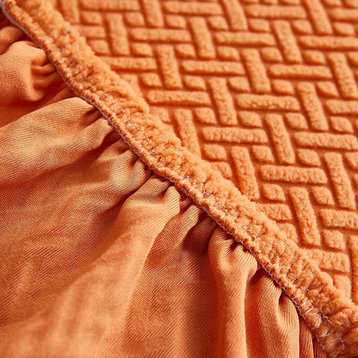 Stretchable sectional sofa cover in vibrant tangerine, snug fit, durable fabric, ideal for home decor and furniture protectio