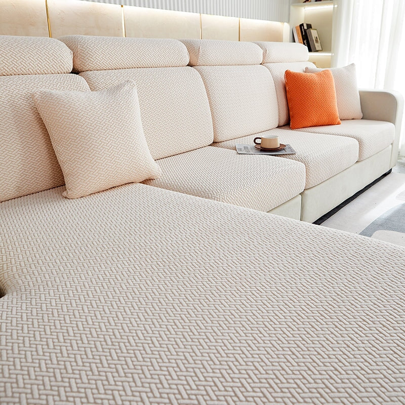 Stretchable sectional sofa cover in vibrant tangerine, snug fit, durable fabric, ideal for home decor and furniture protectio