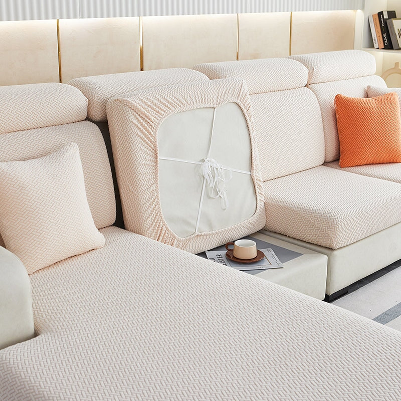 Stretchable sectional sofa cover in vibrant tangerine, snug fit, durable fabric, ideal for home decor and furniture protectio