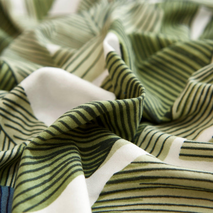 "Stretchy Split Leaf sofa cover with nature-inspired pattern fits various sofas, adds style, and offers protection against sp