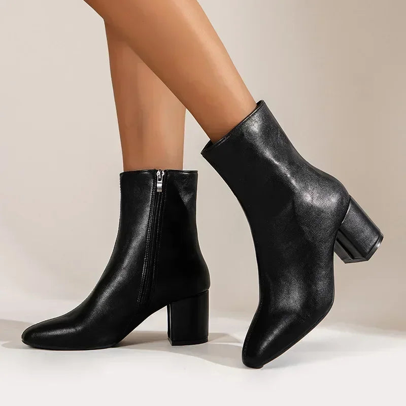 "Stylish women's black/cream pointed toe ankle boots; elegant with modern flair for casual or formal occasions."