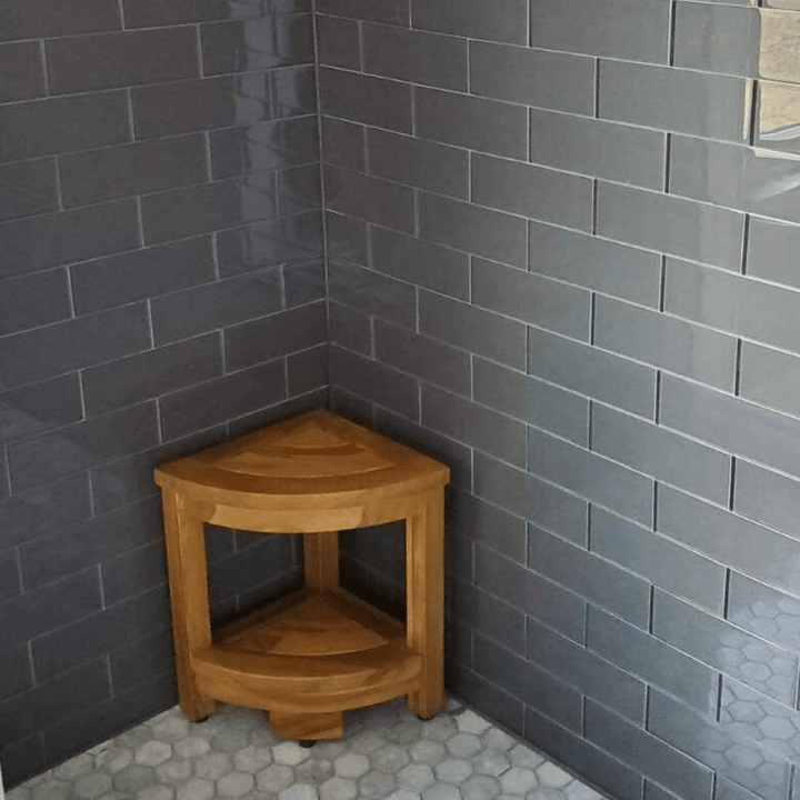 Teak shower corner bench with storage, compact design, made of durable teak wood, ideal for holding toiletries.