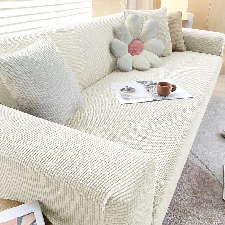 "Textured stretch sofa cover in beige, snug fit for sofas, non-slip, adds elegance, protects against spills and wear."