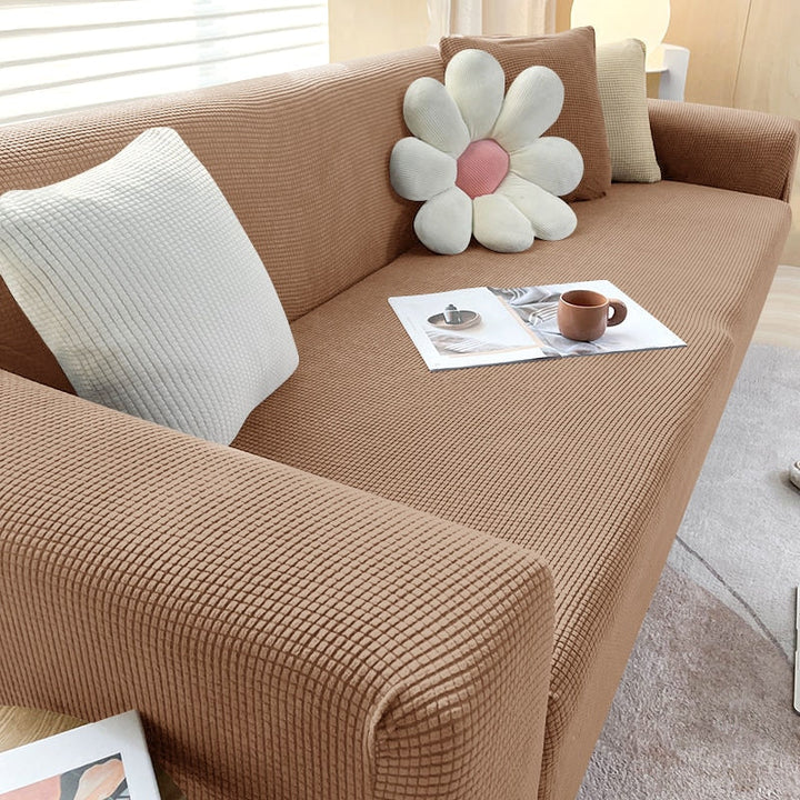 "Textured stretch sofa cover in beige, snug fit for sofas, non-slip, adds elegance, protects against spills and wear."