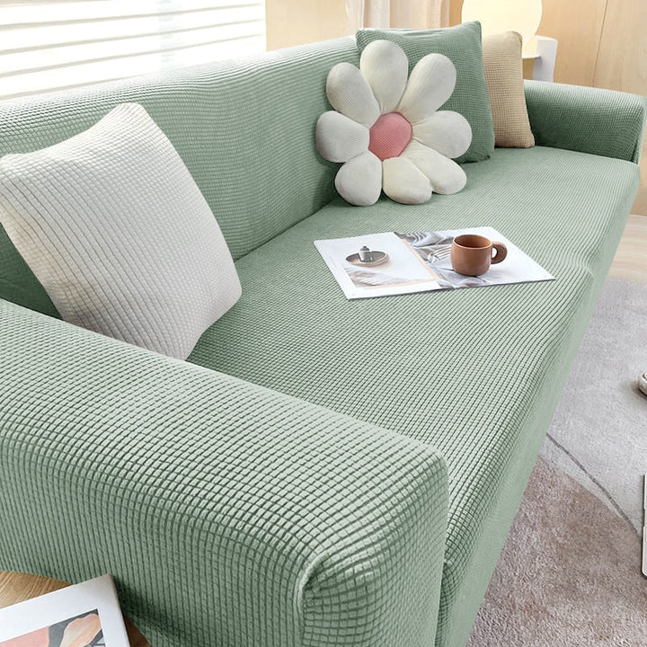 "Textured stretch sofa cover in beige, snug fit for sofas, non-slip, adds elegance, protects against spills and wear."