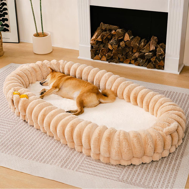 Ultra-soft large plush donut pet bed, creamy faux fur with bolsters for head support, fits humans and dogs, cozy design.