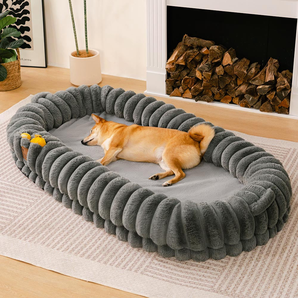 Ultra-soft large plush donut pet bed, creamy faux fur with bolsters for head support, fits humans and dogs, cozy design.