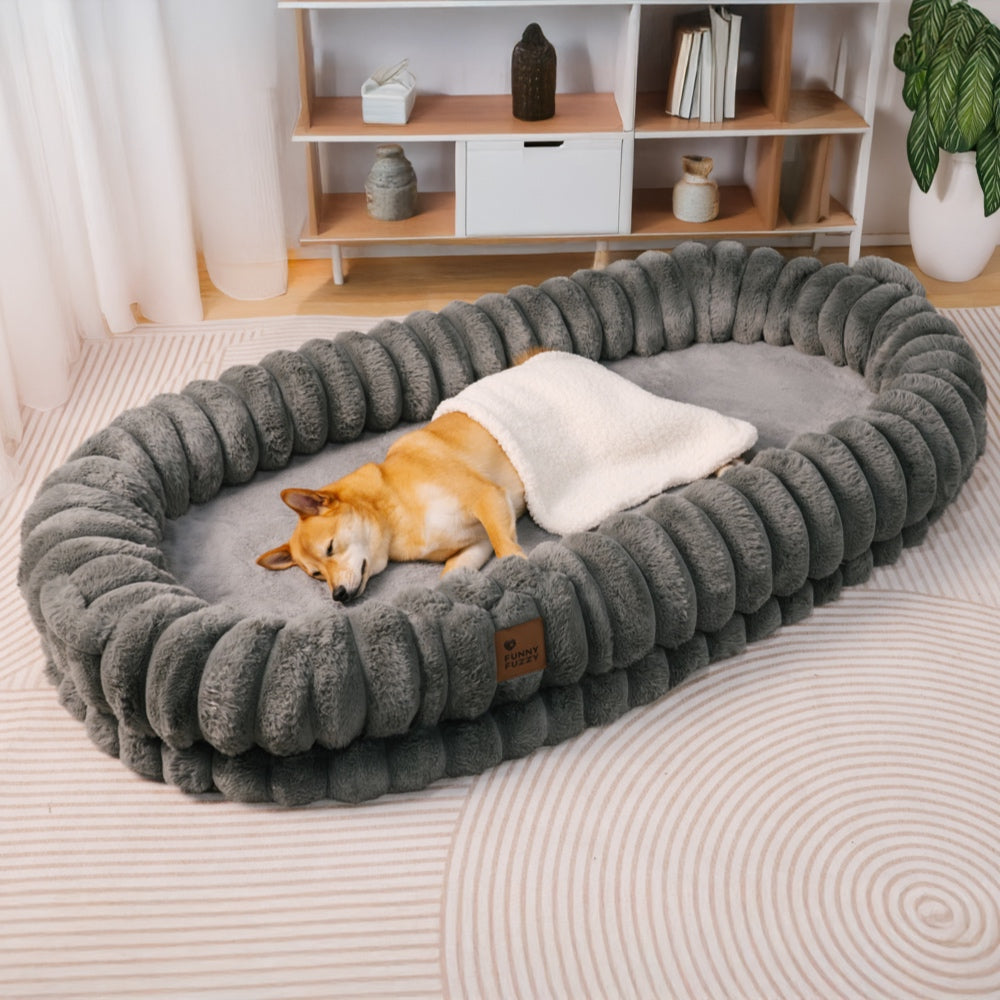Ultra-soft large plush donut pet bed, creamy faux fur with bolsters for head support, fits humans and dogs, cozy design.