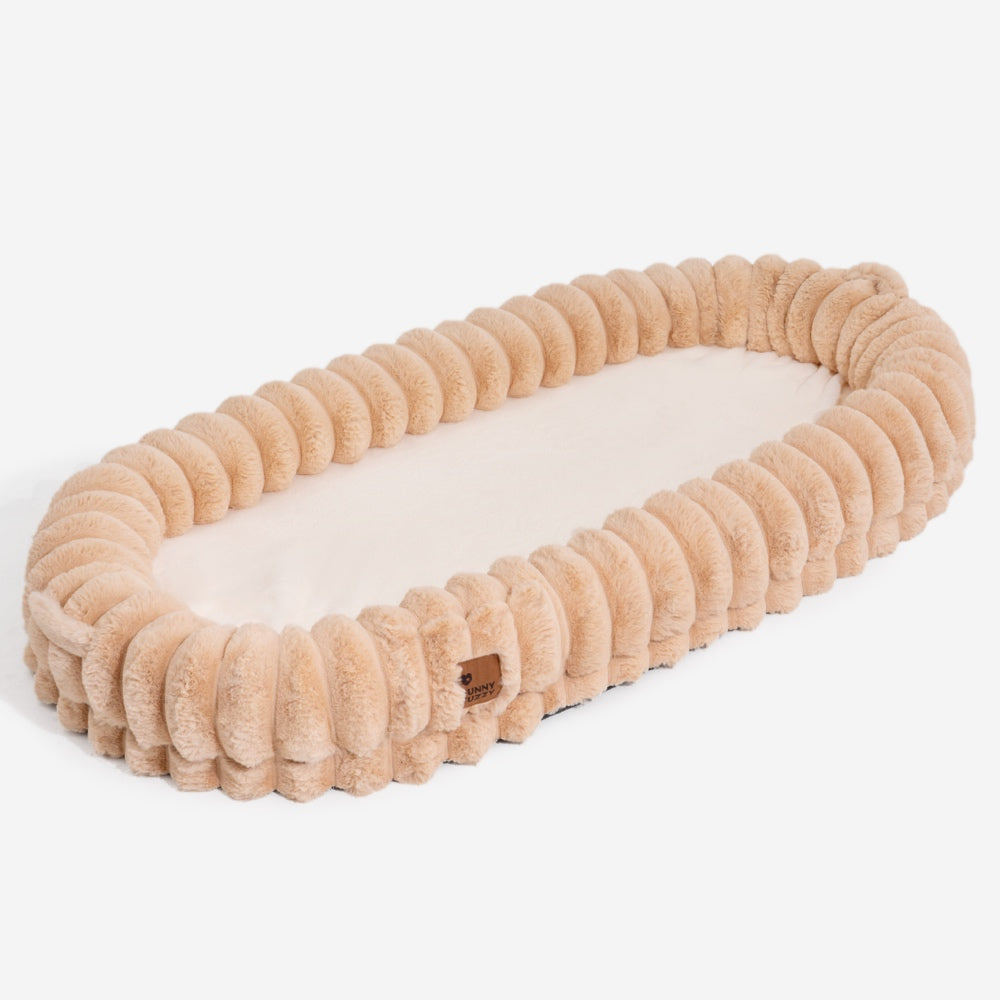 Ultra-soft large plush donut pet bed, creamy faux fur with bolsters for head support, fits humans and dogs, cozy design.