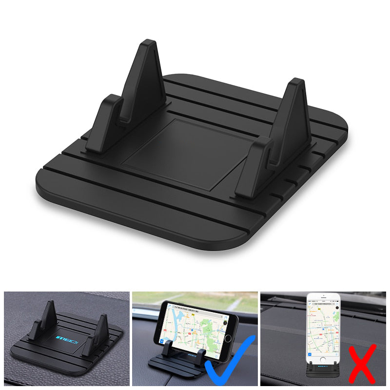 Universal non-slip phone holder for cars with silicone grip, securely holding a smartphone on a dashboard for safe driving.