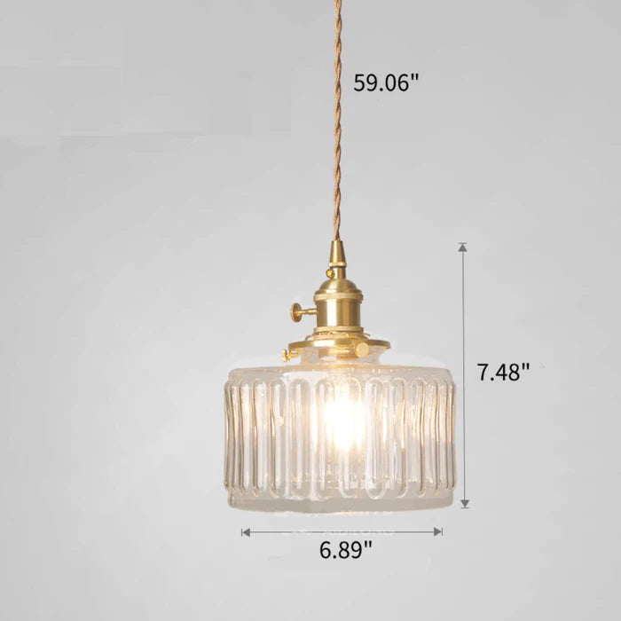 Vintage cylindrical glass pendant lamp casting warm glow; elegant centerpiece for home decor. Perfect for living and dining a