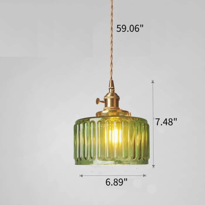 Vintage cylindrical glass pendant lamp casting warm glow; elegant centerpiece for home decor. Perfect for living and dining a