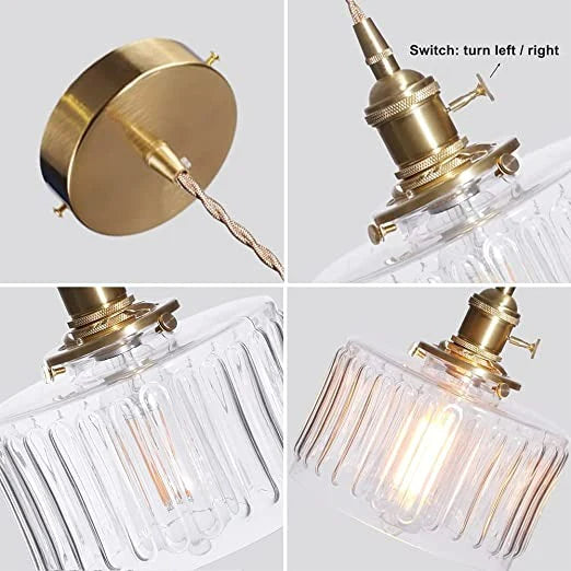 Vintage cylindrical glass pendant lamp casting warm glow; elegant centerpiece for home decor. Perfect for living and dining a
