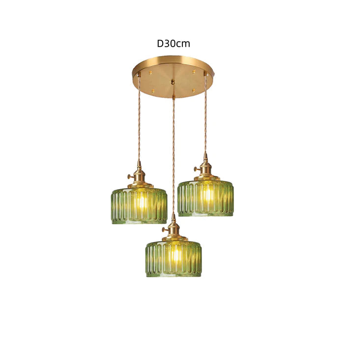 Vintage cylindrical glass pendant lamp casting warm glow; elegant centerpiece for home decor. Perfect for living and dining a