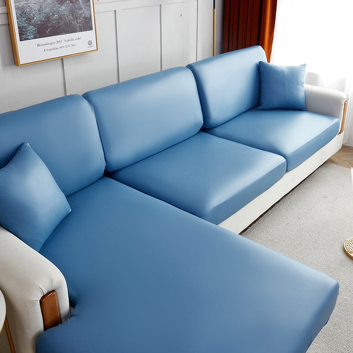 "Waterproof sectional sofa cover in smoke grey, sleek design for leather protection, durable stretchable fabric, snug fit."