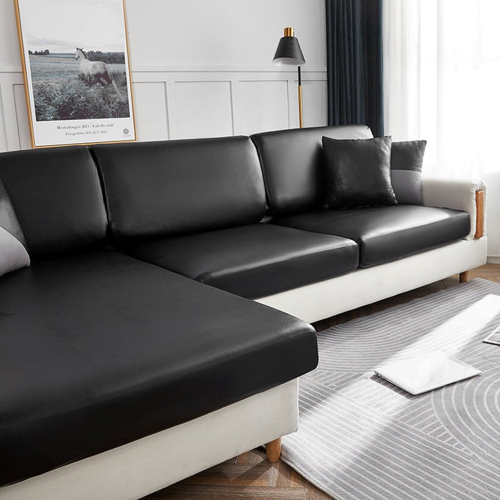 "Waterproof sectional sofa cover in smoke grey, sleek design for leather protection, durable stretchable fabric, snug fit."
