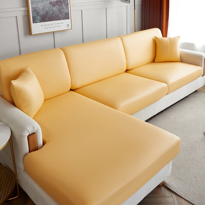 "Waterproof sectional sofa cover in smoke grey, sleek design for leather protection, durable stretchable fabric, snug fit."