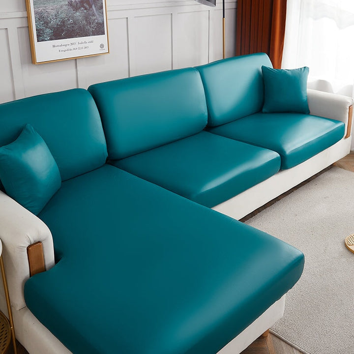 "Waterproof sectional sofa cover in smoke grey, sleek design for leather protection, durable stretchable fabric, snug fit."