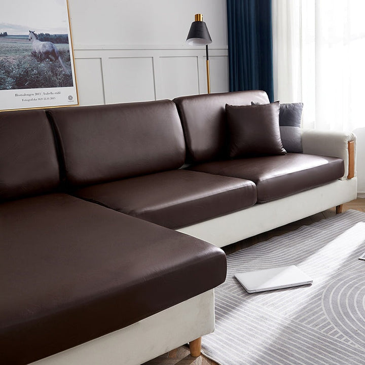 "Waterproof sectional sofa cover in smoke grey, sleek design for leather protection, durable stretchable fabric, snug fit."