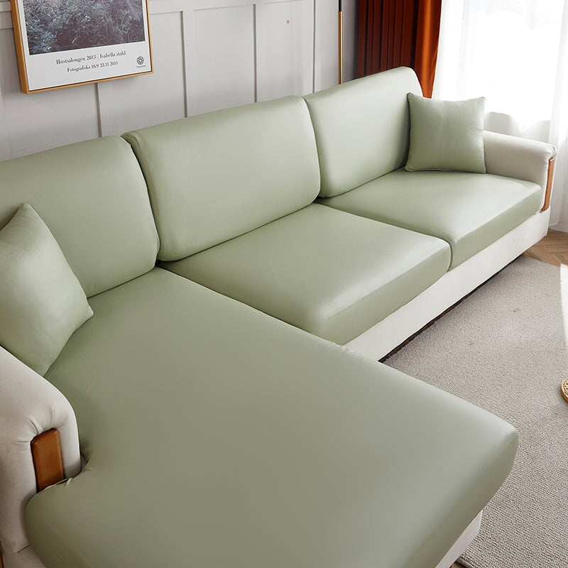 "Waterproof sectional sofa cover in smoke grey, sleek design for leather protection, durable stretchable fabric, snug fit."