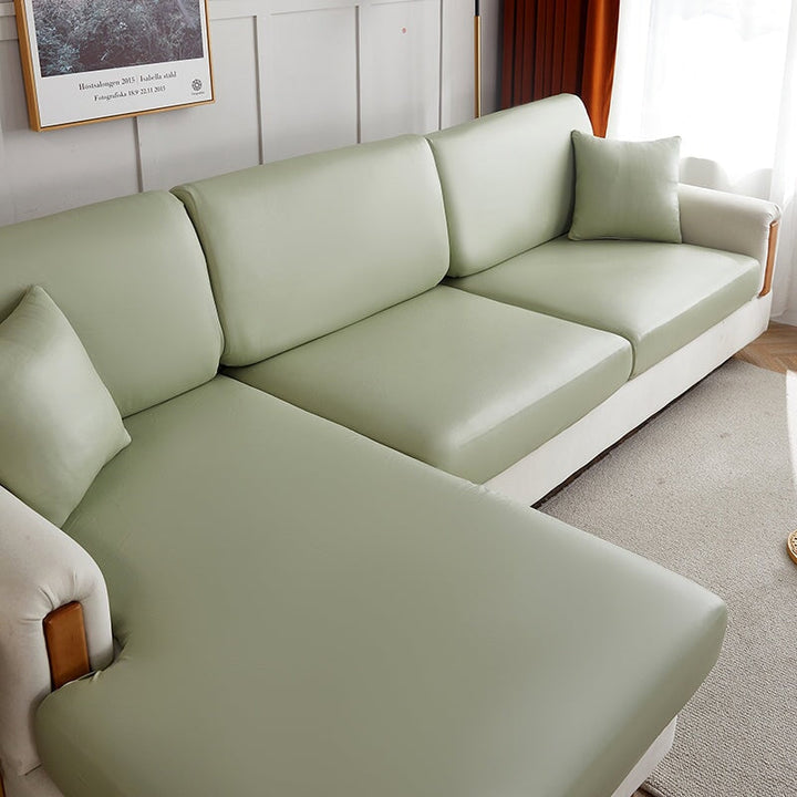 "Waterproof sectional sofa cover in smoke grey, sleek design for leather protection, durable stretchable fabric, snug fit."
