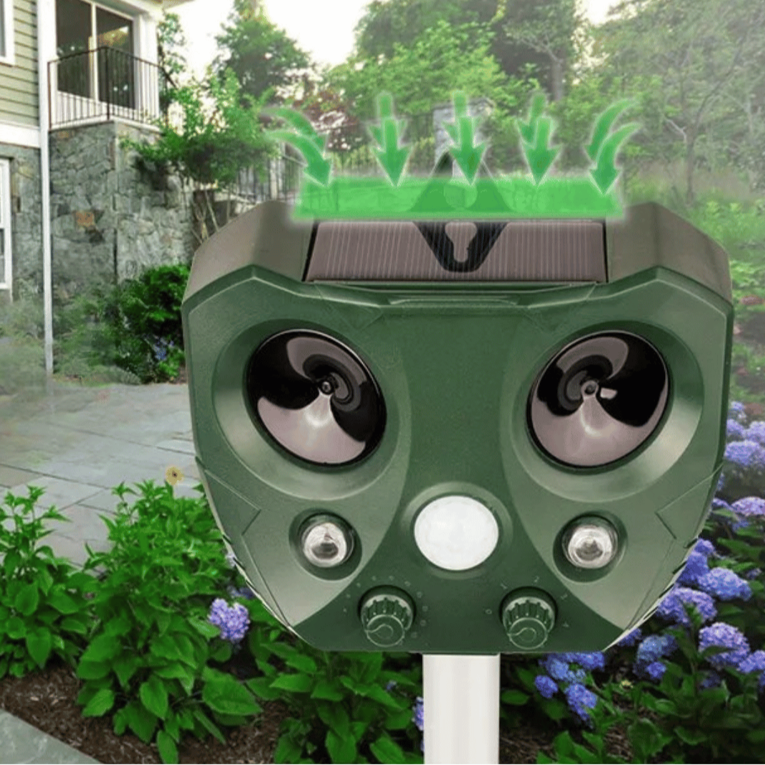 "Weatherproof solar ultrasonic animal repeller in garden, motion-activated to deter pests like cats and rodents."
