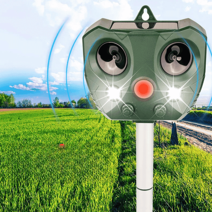 "Weatherproof solar ultrasonic animal repeller in garden, motion-activated to deter pests like cats and rodents."