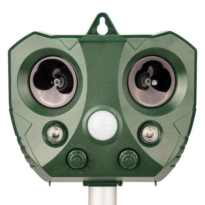 "Weatherproof solar ultrasonic animal repeller in garden, motion-activated to deter pests like cats and rodents."