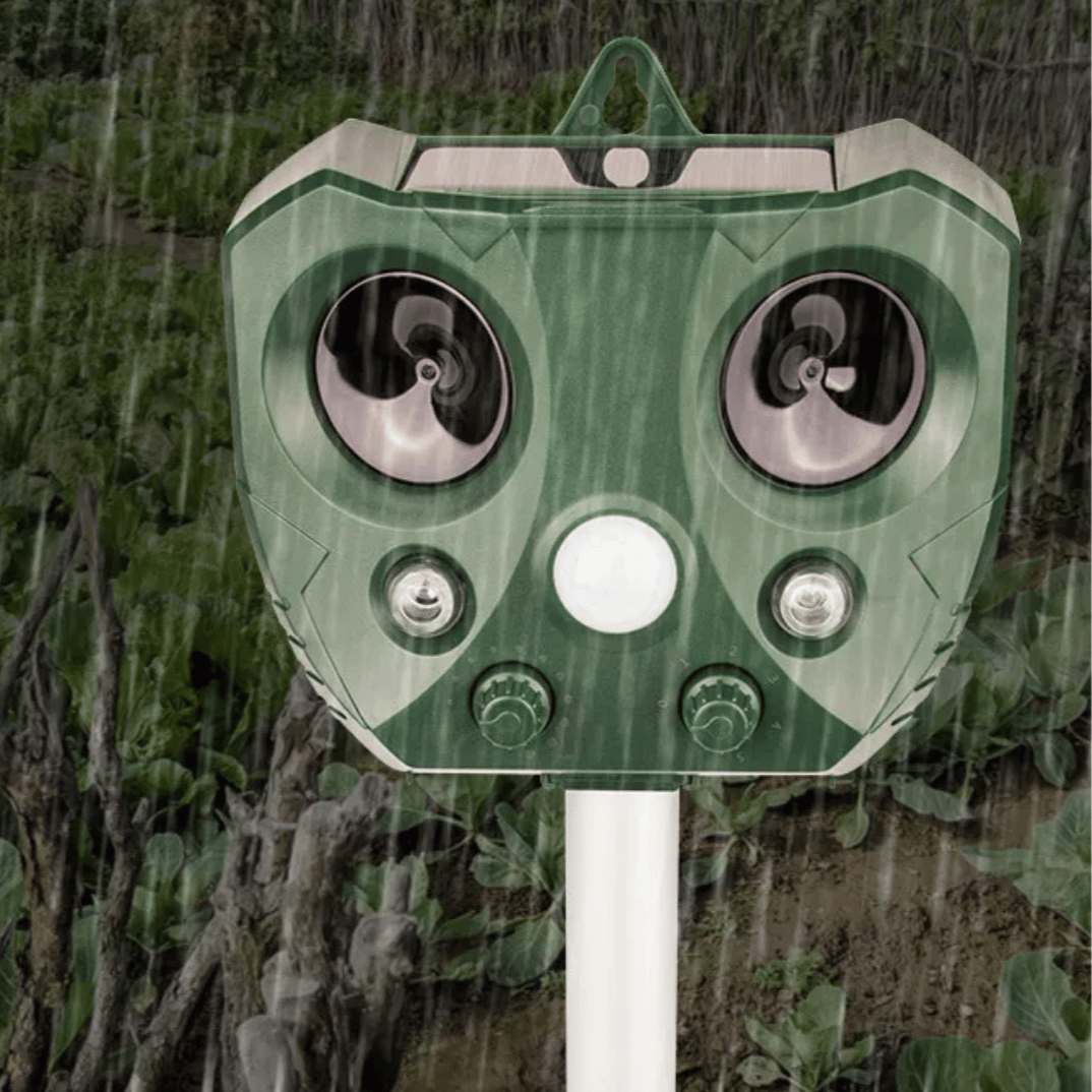 "Weatherproof solar ultrasonic animal repeller in garden, motion-activated to deter pests like cats and rodents."
