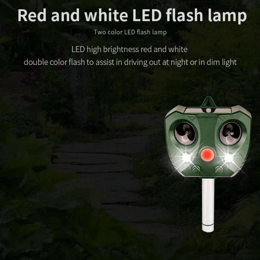 "Weatherproof solar ultrasonic animal repeller in garden, motion-activated to deter pests like cats and rodents."