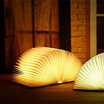 "Whimsical LED book lamp with warm glow, resembling an open book, perfect for cozy decor in bedrooms or study areas."