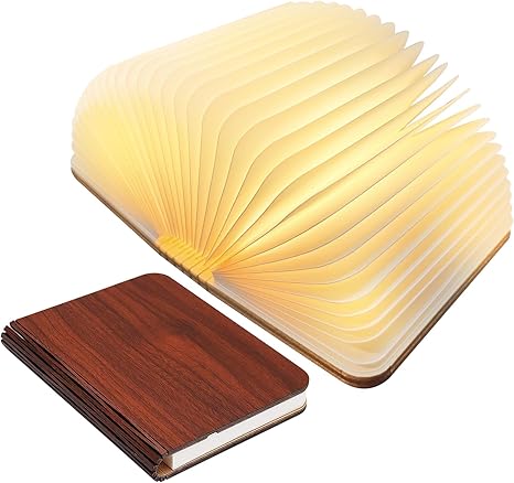"Whimsical LED book lamp with warm glow, resembling an open book, perfect for cozy decor in bedrooms or study areas."