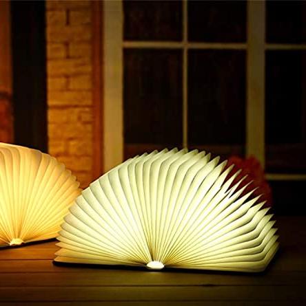 "Whimsical LED book lamp with warm glow, resembling an open book, perfect for cozy decor in bedrooms or study areas."