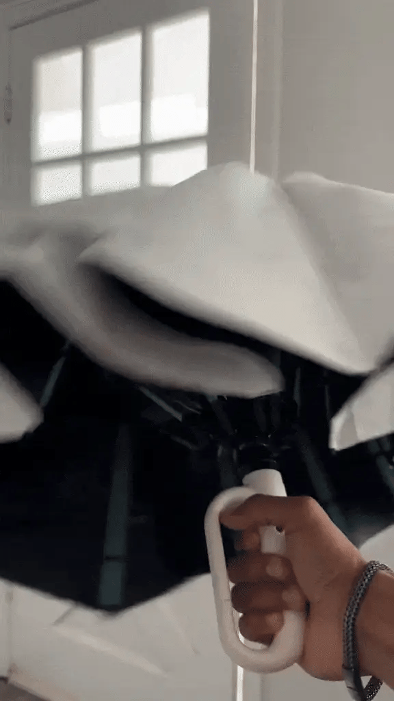 "Windproof automatic folding umbrella with reflective strip, featuring 10-rib construction, reverse folding, and carabiner ha