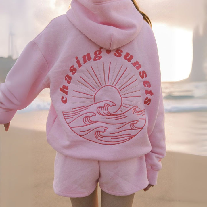 "Womens beige and pink oversized hoodie with graphic print, featuring shades of blue. Fashionable, relaxed fit for casual sty