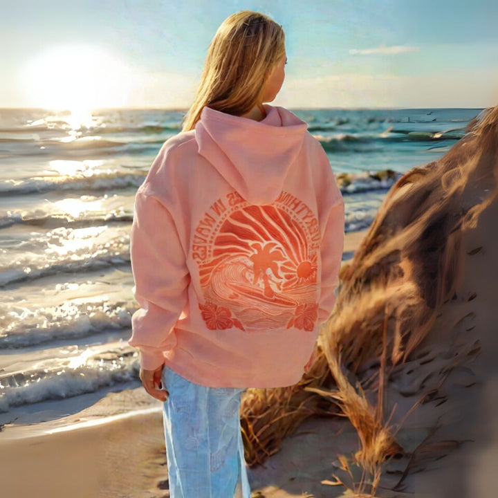 "Womens beige and pink oversized hoodie with graphic print, featuring shades of blue. Fashionable, relaxed fit for casual sty