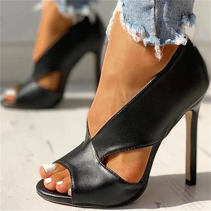"Women's black & brown open-toe stiletto heels with side cutouts, peep-toe design, sleek silhouette, and slip-on style."