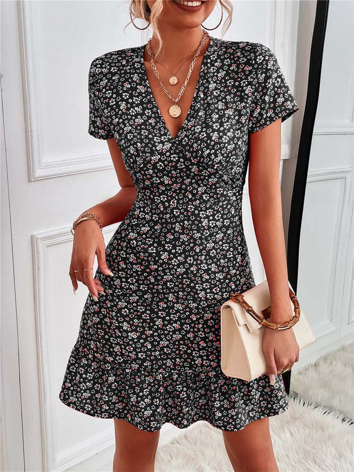 "Women's black floral V-neck mini dress, elegant style, detailed with a vibrant floral pattern for summer comfort and charm."