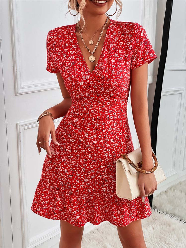 "Women's black floral V-neck mini dress, elegant style, detailed with a vibrant floral pattern for summer comfort and charm."