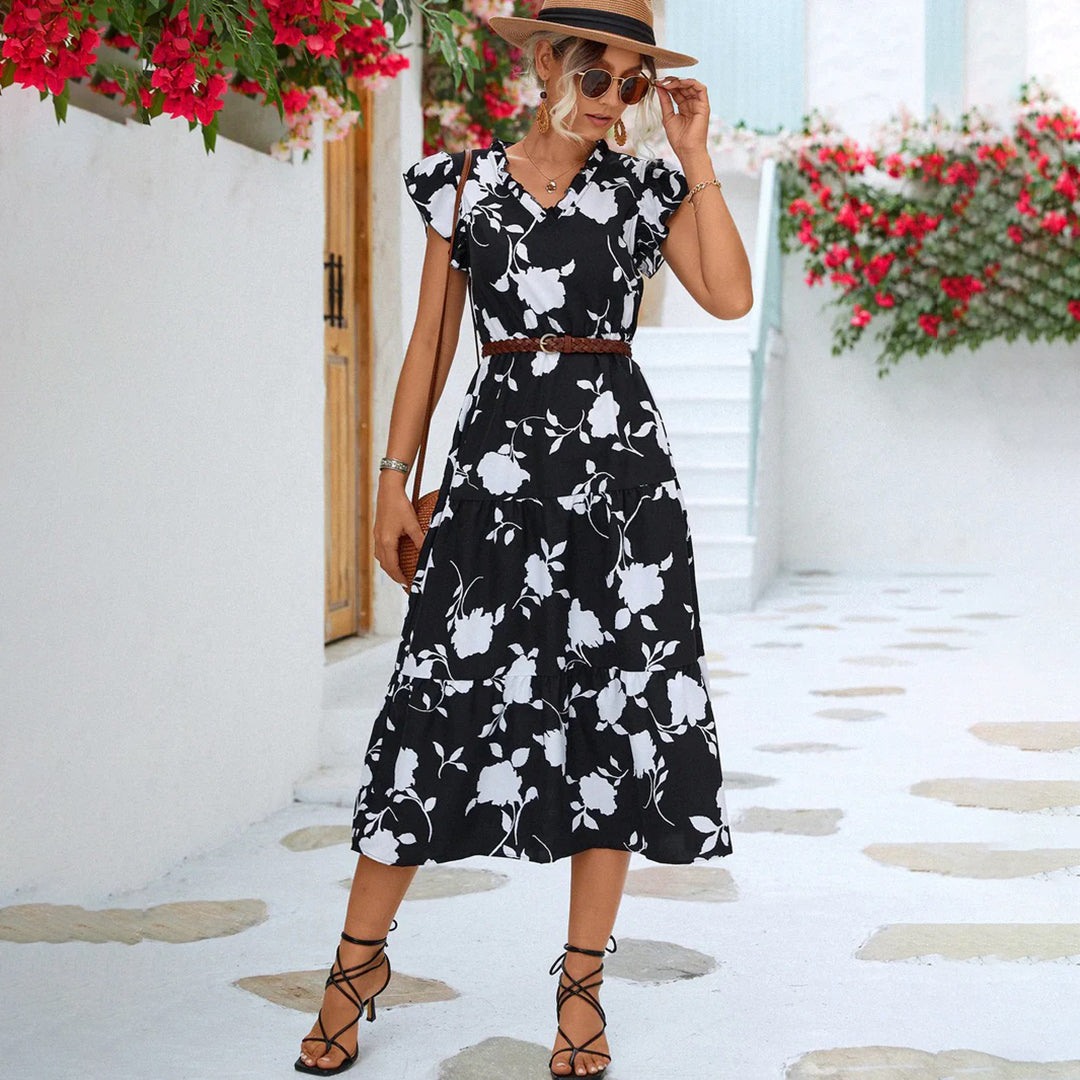 "Women's black midi dress with V-neck, floral print, side view"