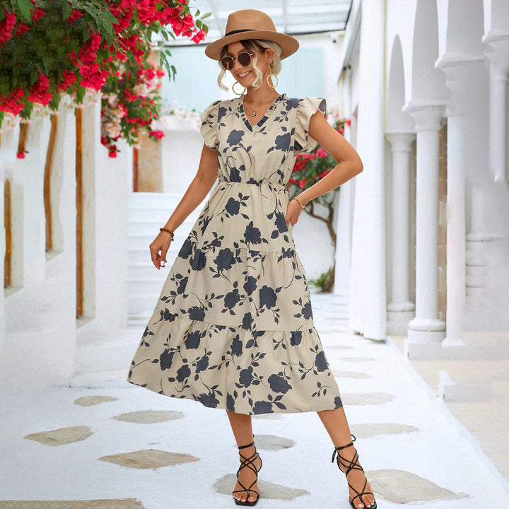 "Women's black midi dress with V-neck, floral print, side view"