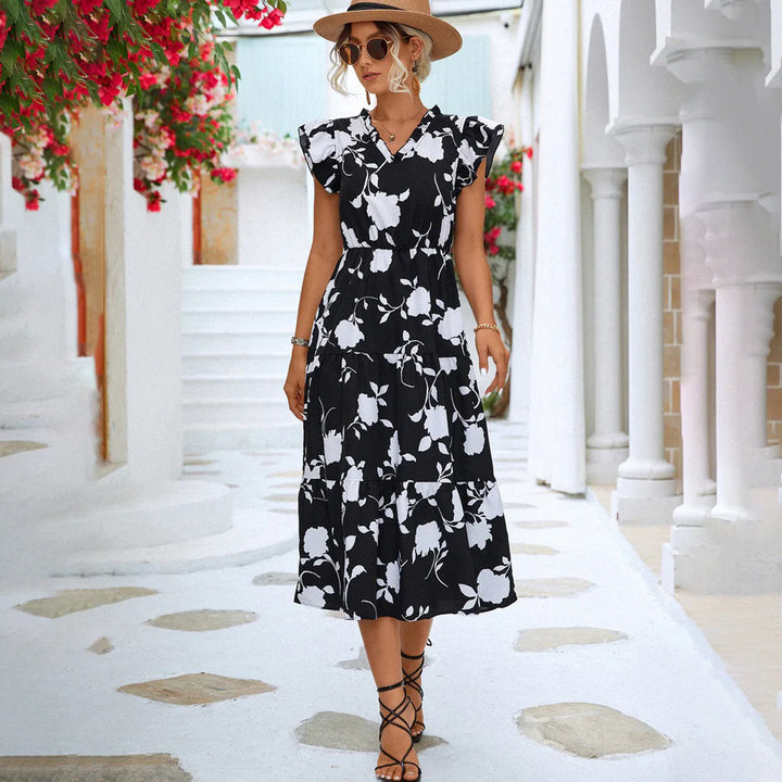 "Women's black midi dress with V-neck, floral print, side view"