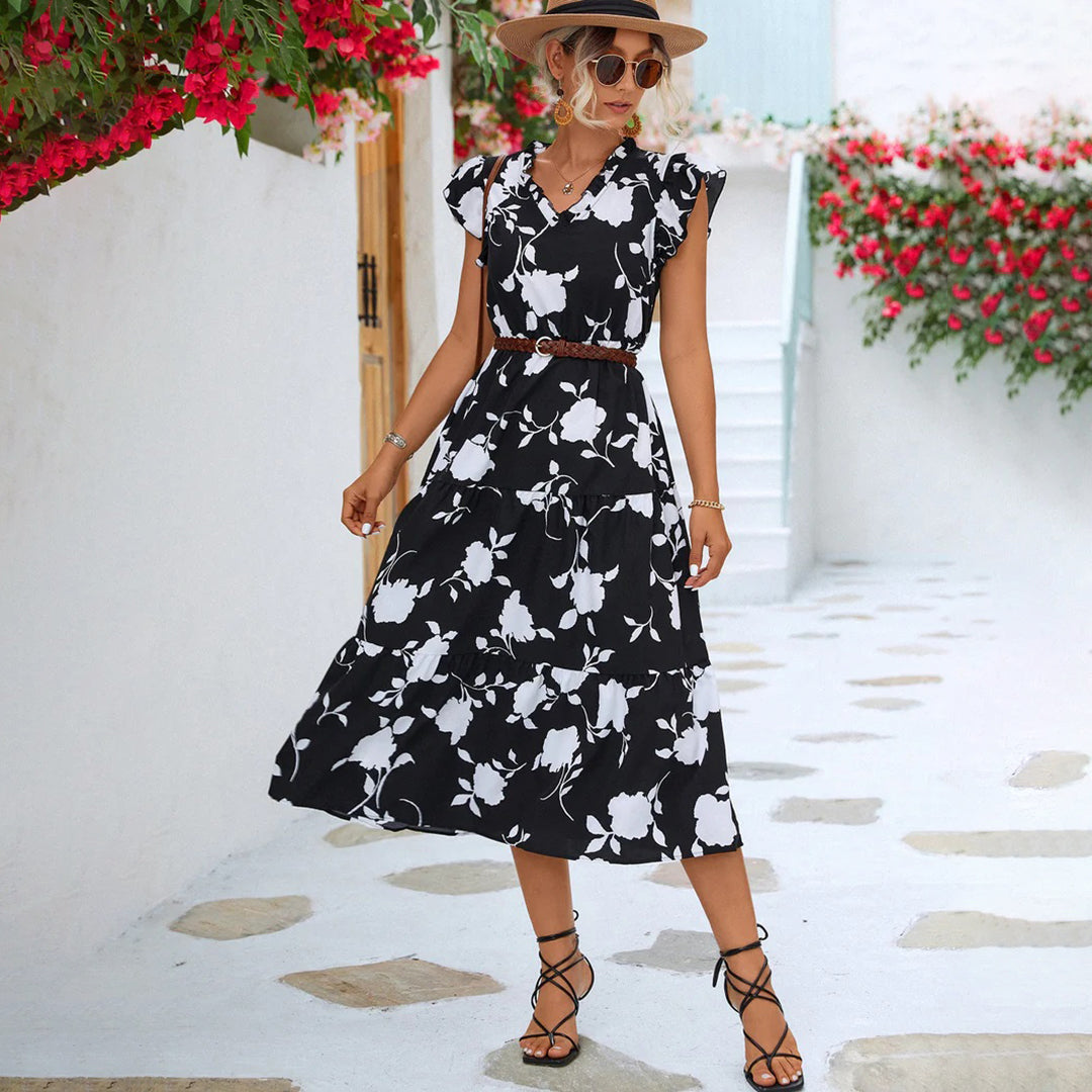 "Women's black midi dress with V-neck, floral print, side view"
