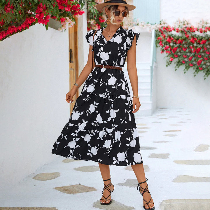 "Women's black midi dress with V-neck, floral print, side view"