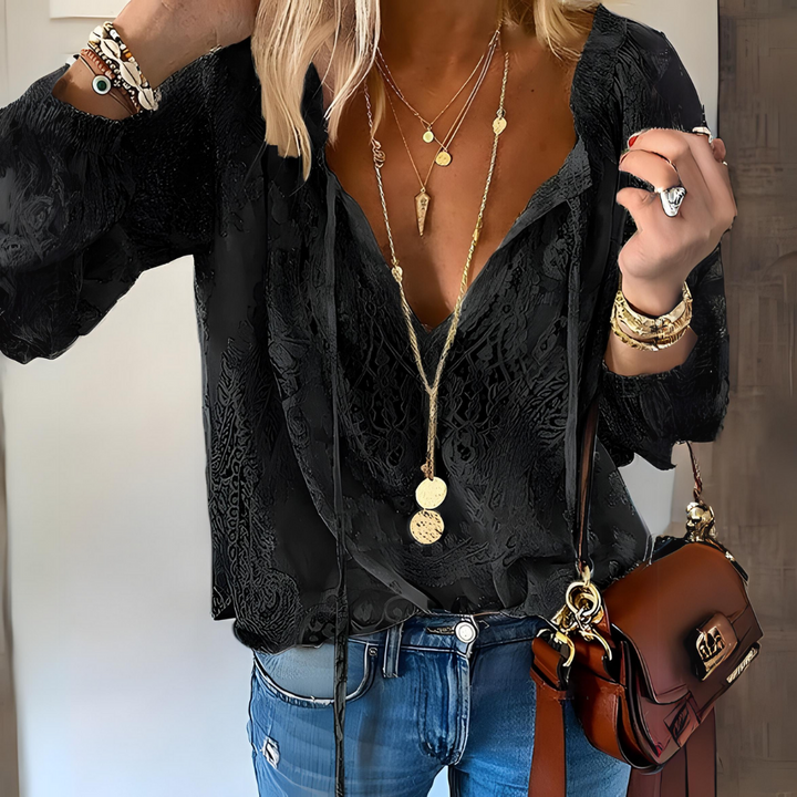 Women's Bohemian crochet blouse with relaxed fit, intricate crochet design, long sleeves, and drawstring neckline.